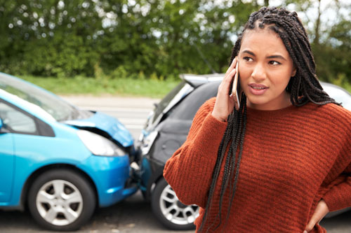 Female motorist calling for auto insurance